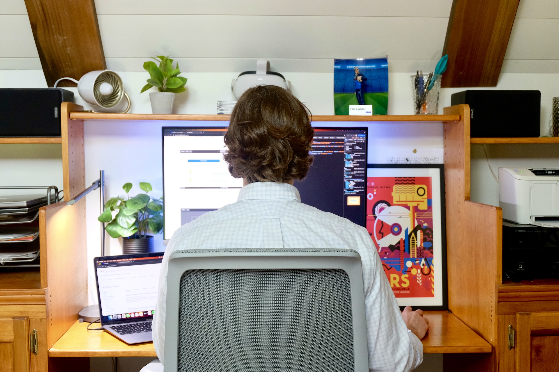 Drew McDowell working in front of a computer display in his home office